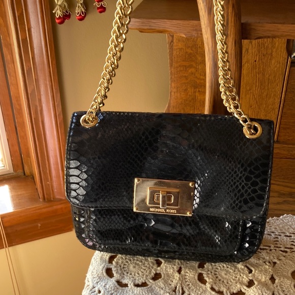 Michael Kors Handbags - Michael Kors woman’s black embossed over the shoulder purse NWOT. Gold hardware.